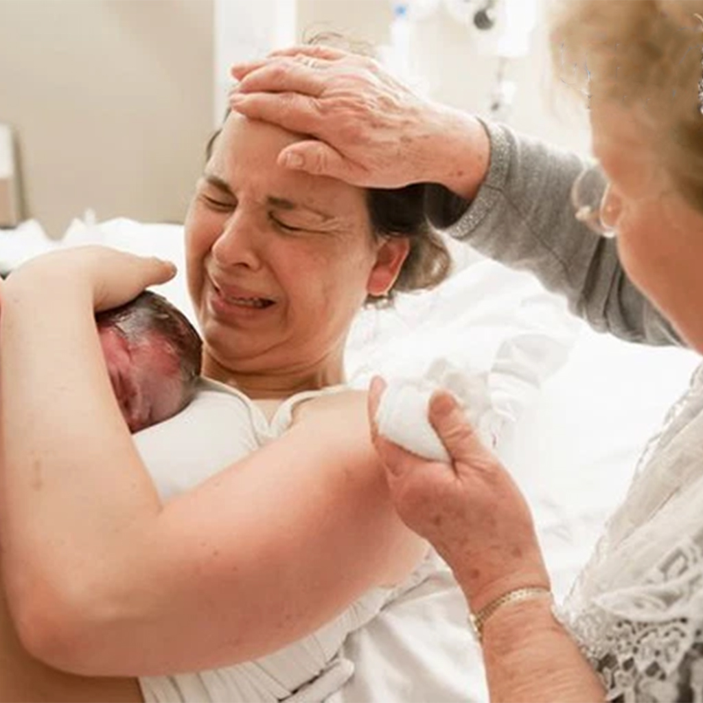 Mothers are seen in a photo series assisting their daughters after childbirth.