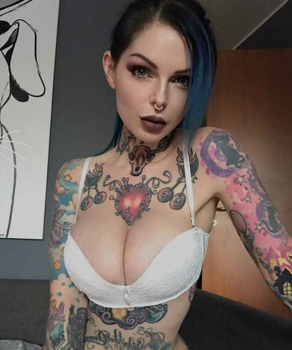 Explore the unique beauty of Riae’s tattoos and be mesmerized by her captivating body art!