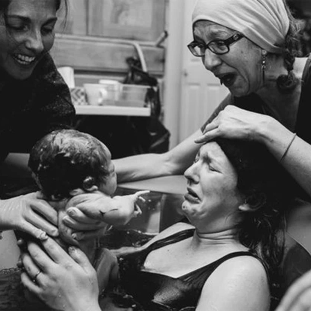 Mothers are seen in a photo series assisting their daughters after childbirth.