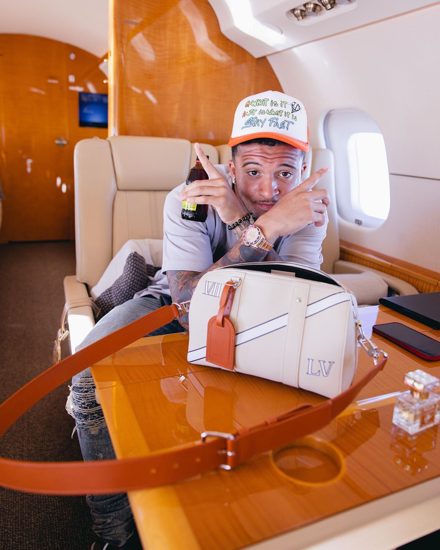 Inside Man Utd star Jadon Sancho’s private holiday jet including luxury diamond watches and Louis Vuitton bags