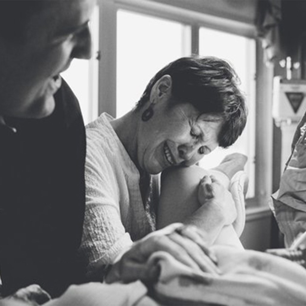 Mothers are seen in a photo series assisting their daughters after childbirth.