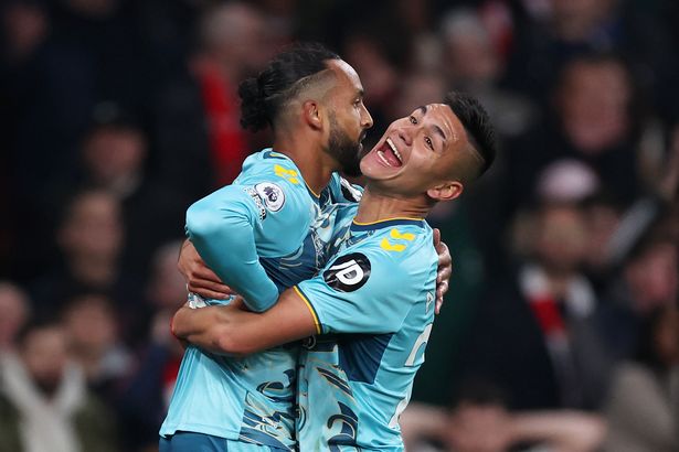 Theo Walcott of Southampton (L) celebrates with teammate Carlos Alcaraz after scoring the team's second goal during the Premier League match between Arsenal FC and Southampton FC at Emirates Stadium on April 21, 2023 in London, England.