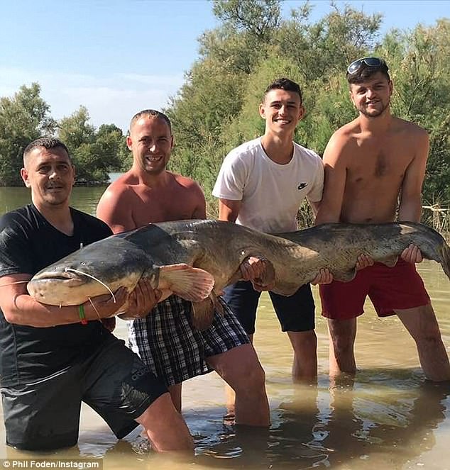Manchester City starlet Phil Foden enjoys very successful fishing trip in sunny Spain as he poses with massive catfish and carp