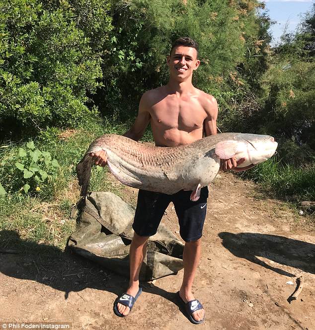 Manchester City starlet Phil Foden enjoys very successful fishing trip in sunny Spain as he poses with massive catfish and carp