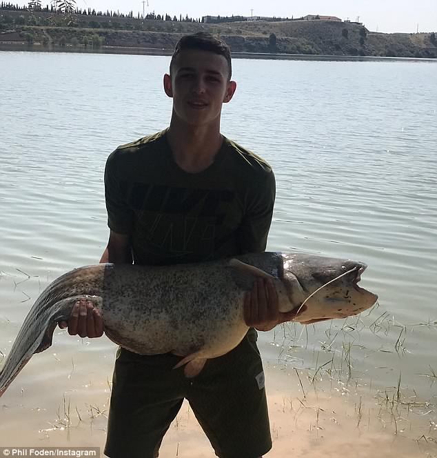 Manchester City starlet Phil Foden enjoys very successful fishing trip in sunny Spain as he poses with massive catfish and carp