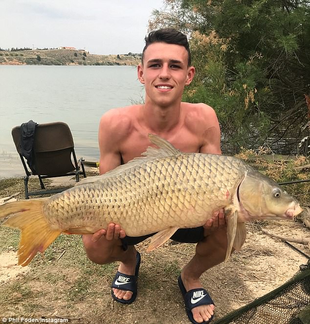 Manchester City starlet Phil Foden enjoys very successful fishing trip in sunny Spain as he poses with massive catfish and carp