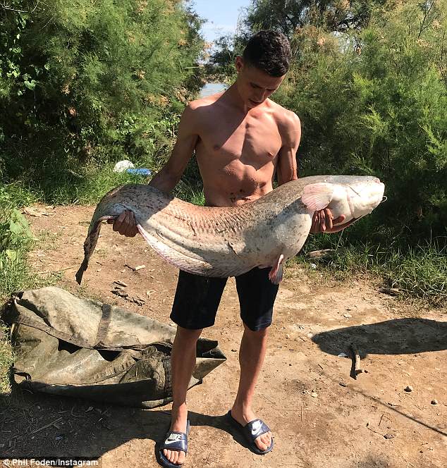 Manchester City starlet Phil Foden enjoys very successful fishing trip in sunny Spain as he poses with massive catfish and carp