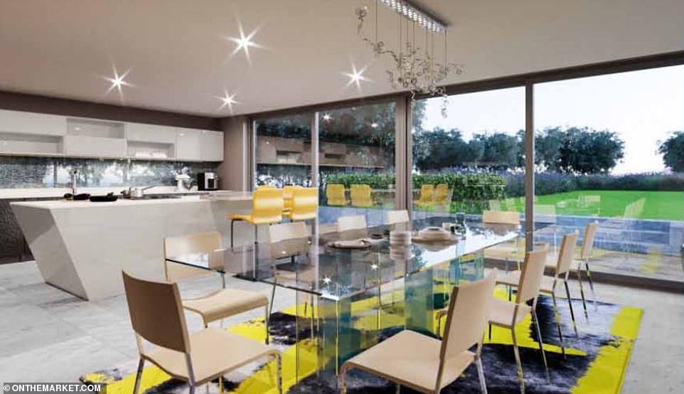 The kitchen-diner looks out to the Ƅack garden of the property through huge sliding glass doors