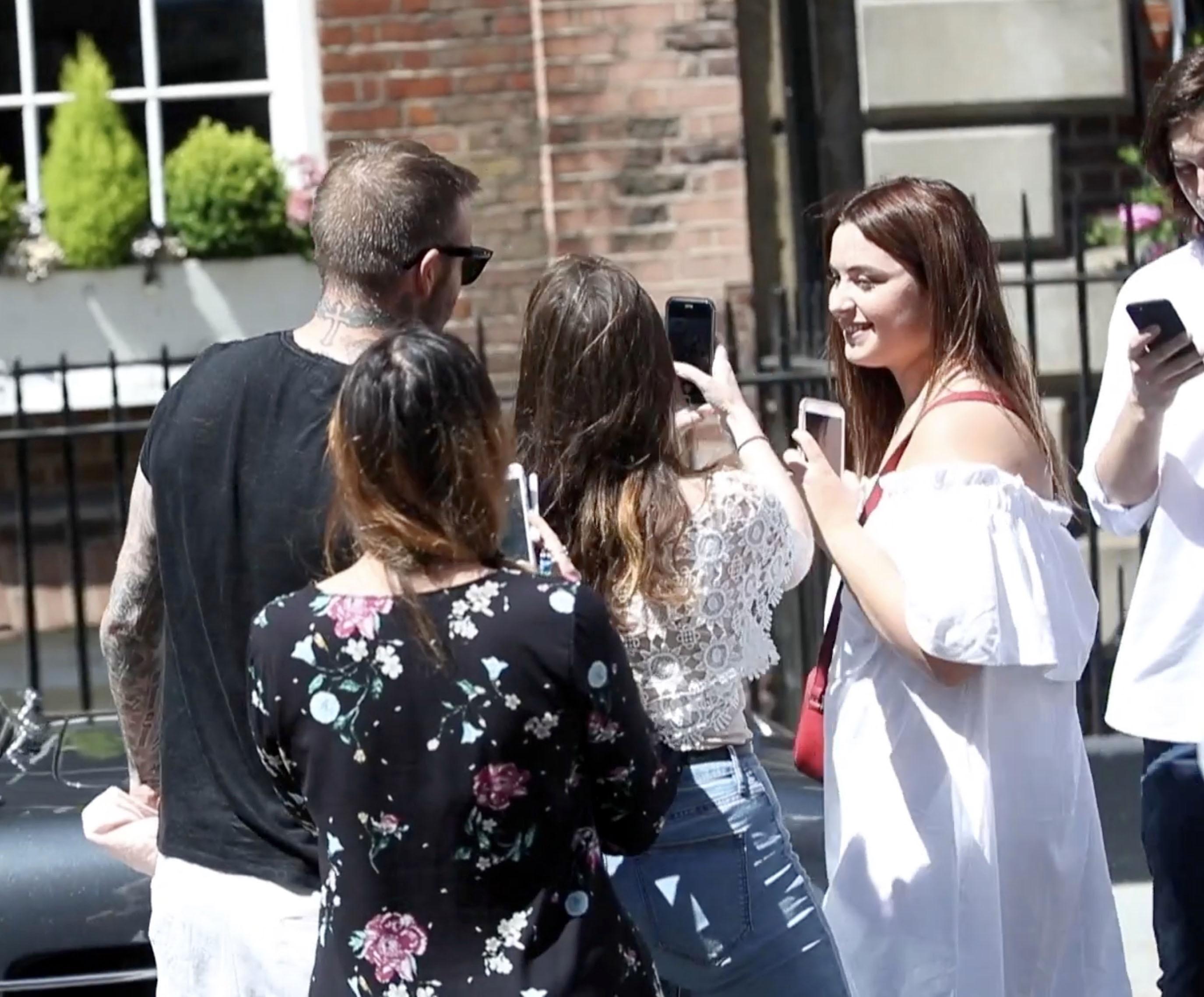  David Beckham didn't mind the attention as female fans swarmed around him in London's Mayfair