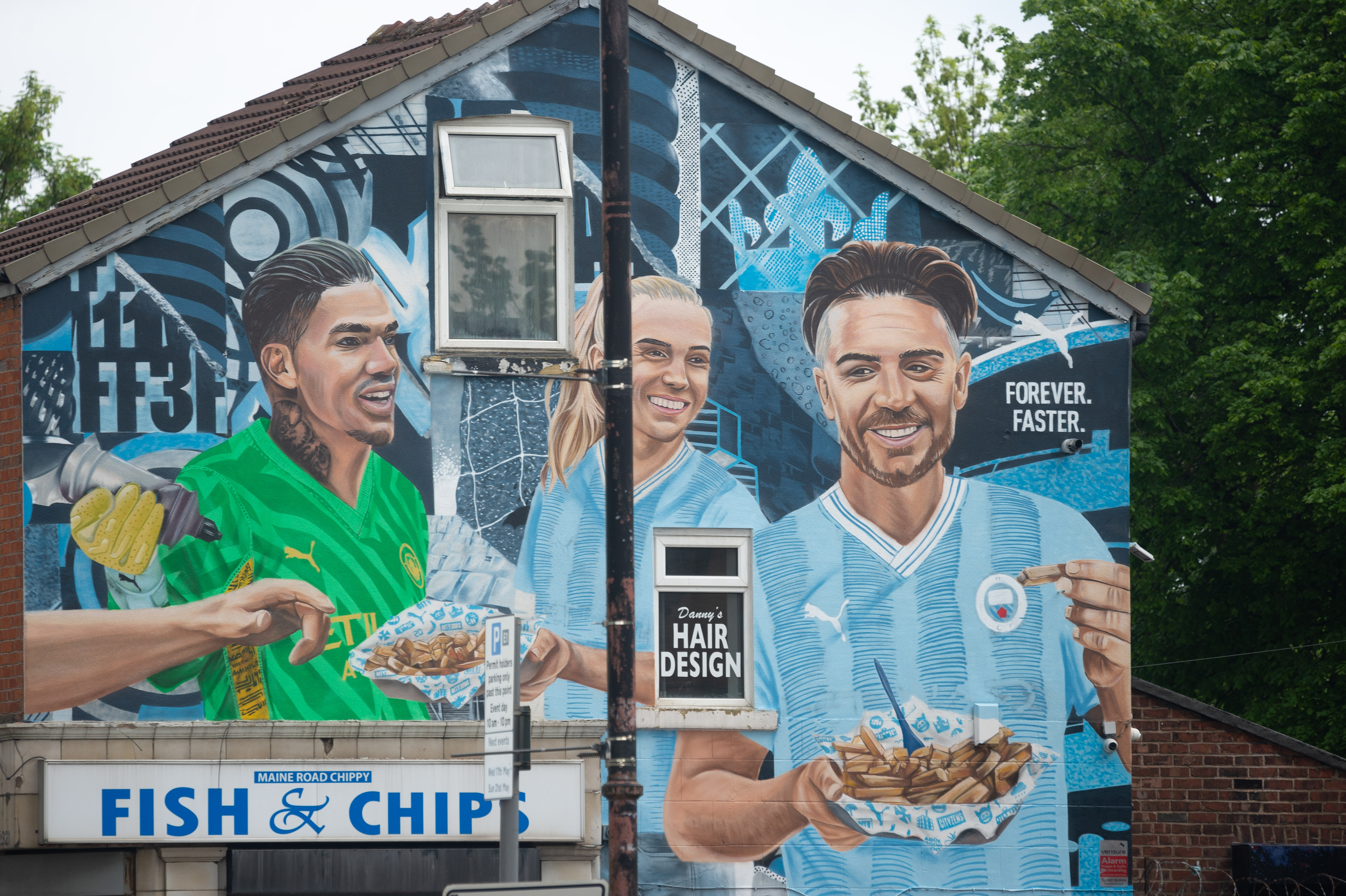 Jack Grealish is joined by Ederson and Esme Morgan in the fish and chip shop mural