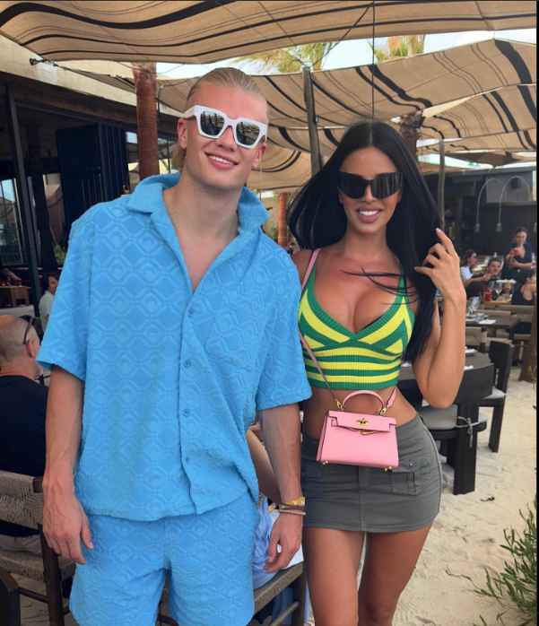 The only thing bigger than Erling Haaland's smile as he walks with Ivana Knoll in Ibiza is his pair of sunglasses